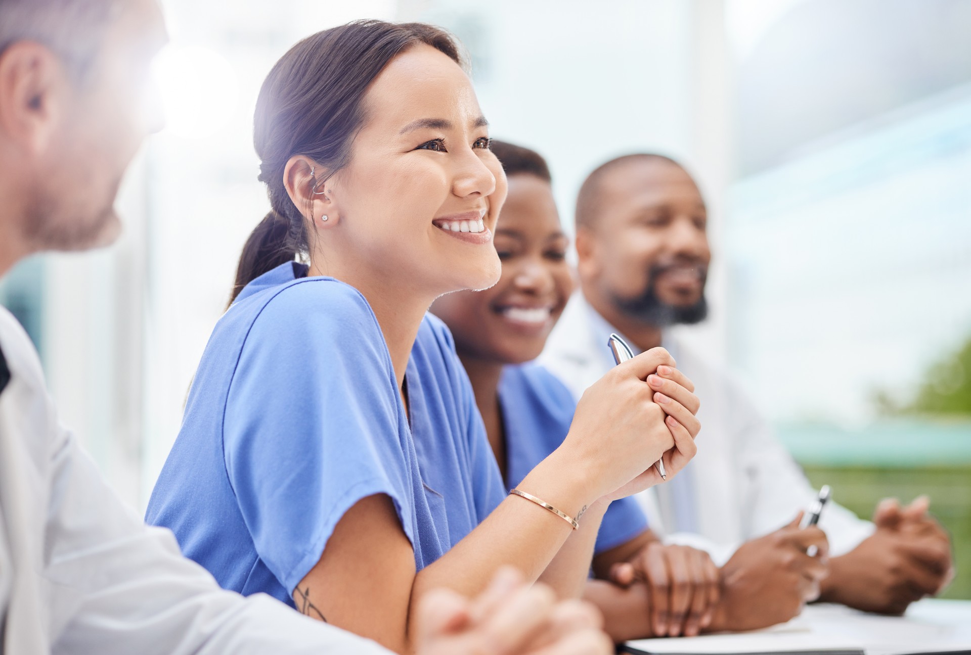 Shot of a doctor sitting alongside his colleagues during a meeting in a hospital boardroom Shot of a doctor sitting alongside his colleagues during a meeting in a hospital boardroom